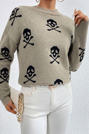 Khaki knit sweater with allover black skull and crossbones motif, mock neck, long sleeves.