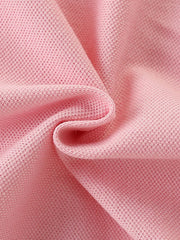 Pink cotton blend baby dress fabric detail with pique knit texture.