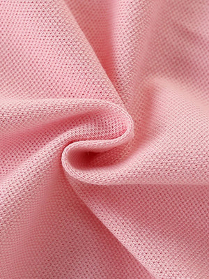 Pink cotton blend baby dress fabric detail with pique knit texture.