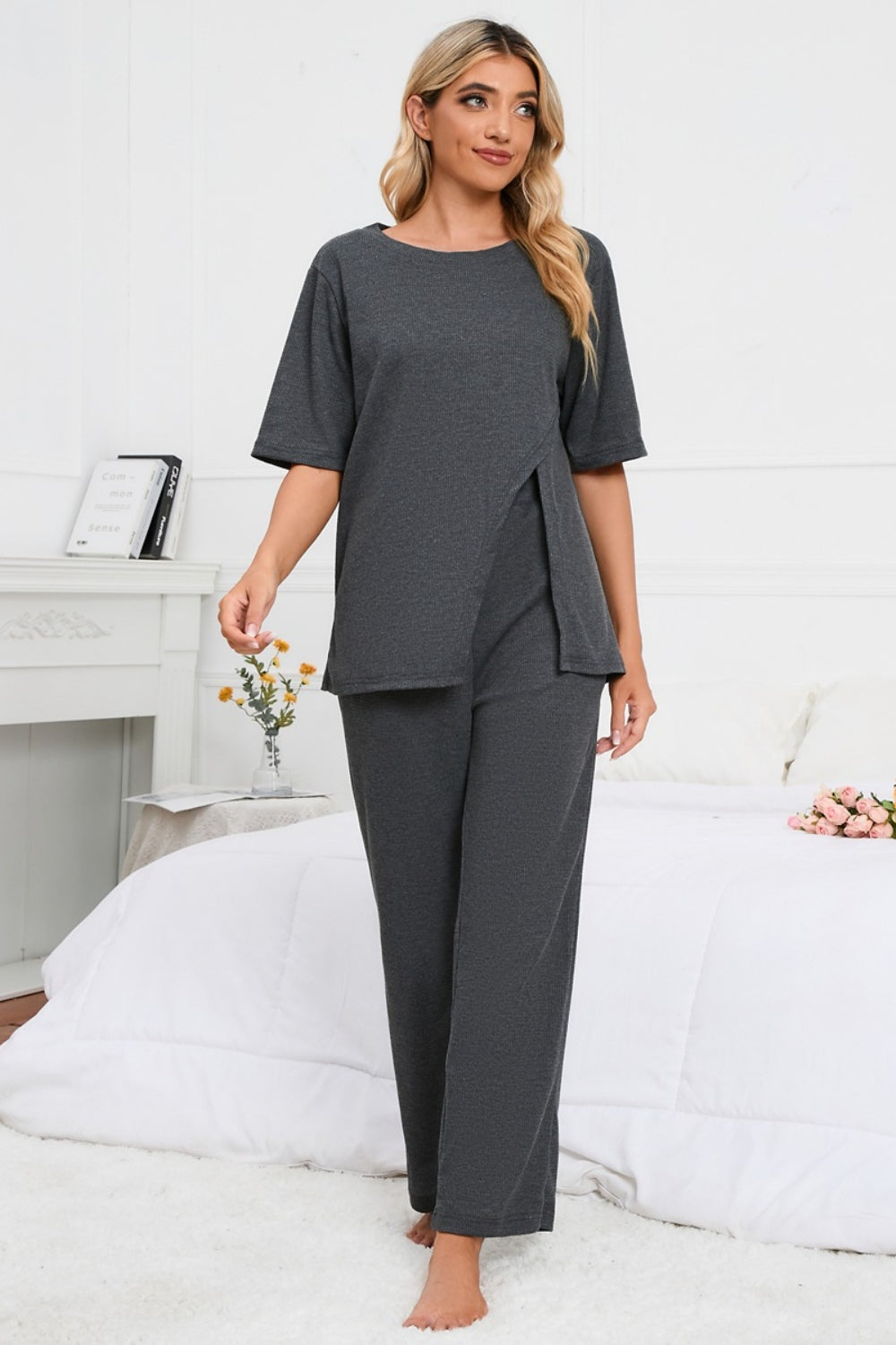 Dark gray loungewear set with asymmetric slit tee and wide leg pants.