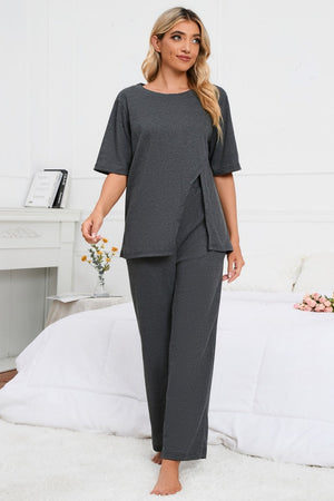 Dark gray loungewear set with asymmetric slit tee and wide leg pants.