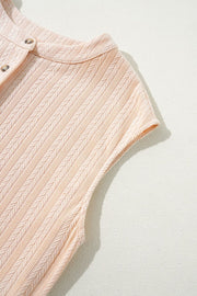 Textured ribbed sleeveless collar jumpsuit in eggshell with button detail.