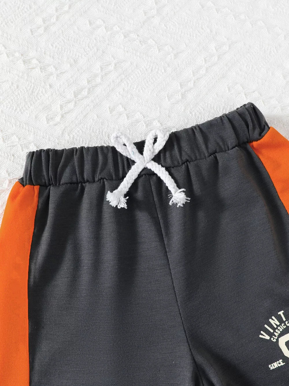 Color block baby set with drawstring waist and orange side stripe detail.
