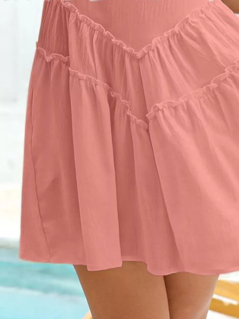 Apricot frill tiered mini dress with ruffled neckline and hem.