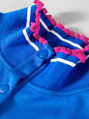 Blue polo shirt with white stripes and pink frill collar detail and button closure