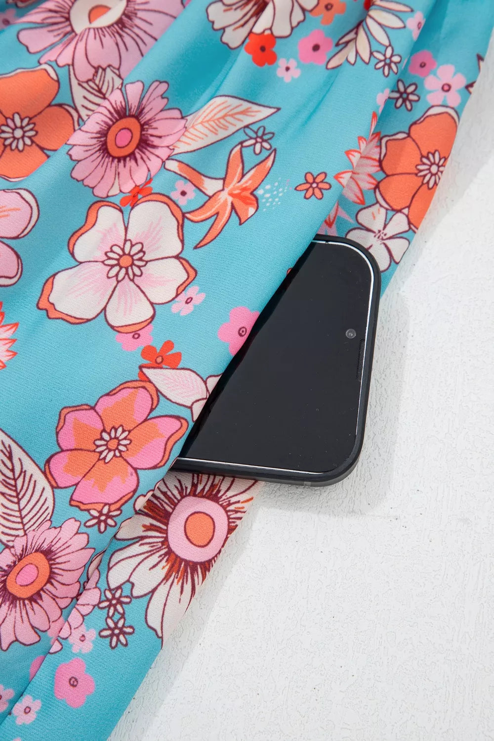 Maxi dress with vibrant floral print and side pocket detail.
