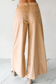 Polka dot wide-leg maternity trousers in tan with white dots, featuring a drawstring waist and back pockets.