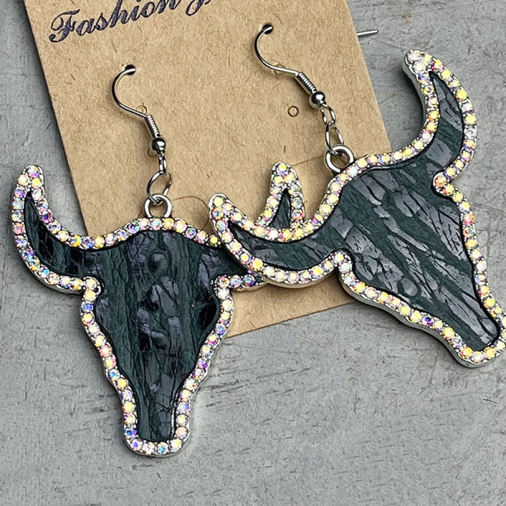 Crystal-trimmed bull skull earrings in black with iridescent rhinestone detail.