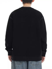 Black oversized long-sleeve sweatshirt with contrast stitching detail.