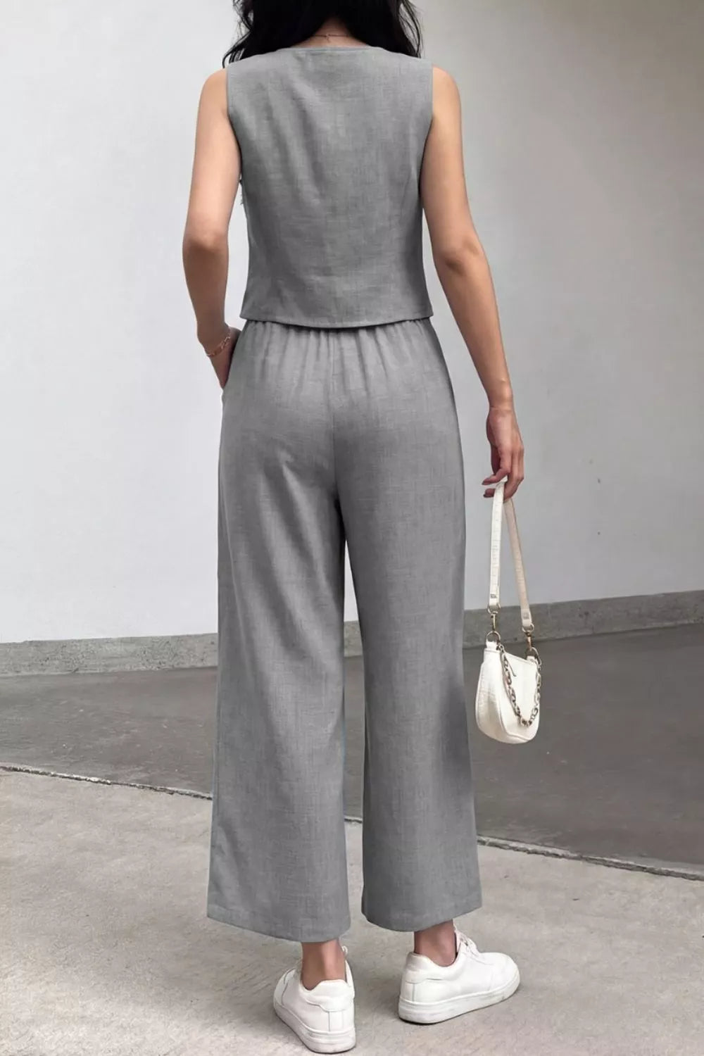 Gray linen-blend two-piece set with sleeveless crop top and wide-leg pants.