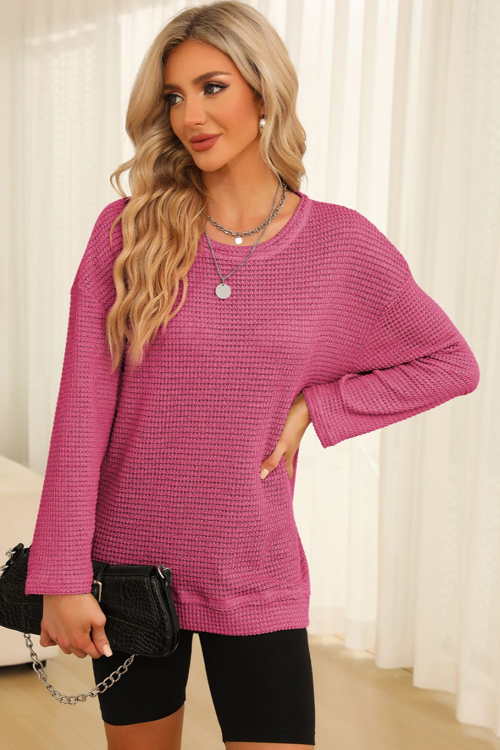 Waffle knit oversized top in pink with crew neck and slit hem detail.