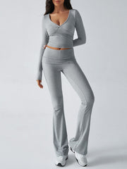 Light gray cross-front long sleeve crop top and flare lounge pants set.