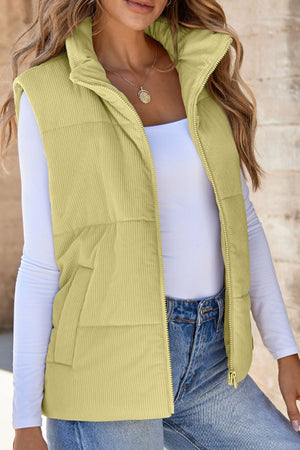 Corduroy padded vest in sage with zip front and stand collar.