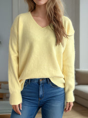 Light yellow relaxed-fit V-neck knit sweater with ribbed hem and cuffs.