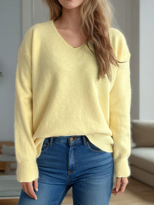 Light yellow relaxed-fit V-neck knit sweater with ribbed hem and cuffs.
