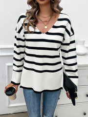 Oversized black and white stripe V-neck knit sweater with long sleeves.