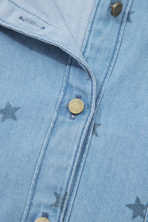 Light blue denim shirt with black star print, button front, and brass button detail.