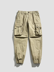 Khaki cargo joggers with flap pockets and elastic cuffs.