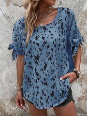 Sky blue Dalmatian print blouse with bow sleeves and a boatneck.