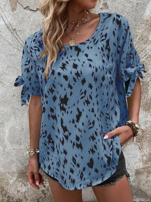 Sky blue Dalmatian print blouse with bow sleeves and a boatneck.