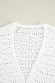 White open-knit dolman sleeve cardigan with a V-neck and breathable acrylic fabric.