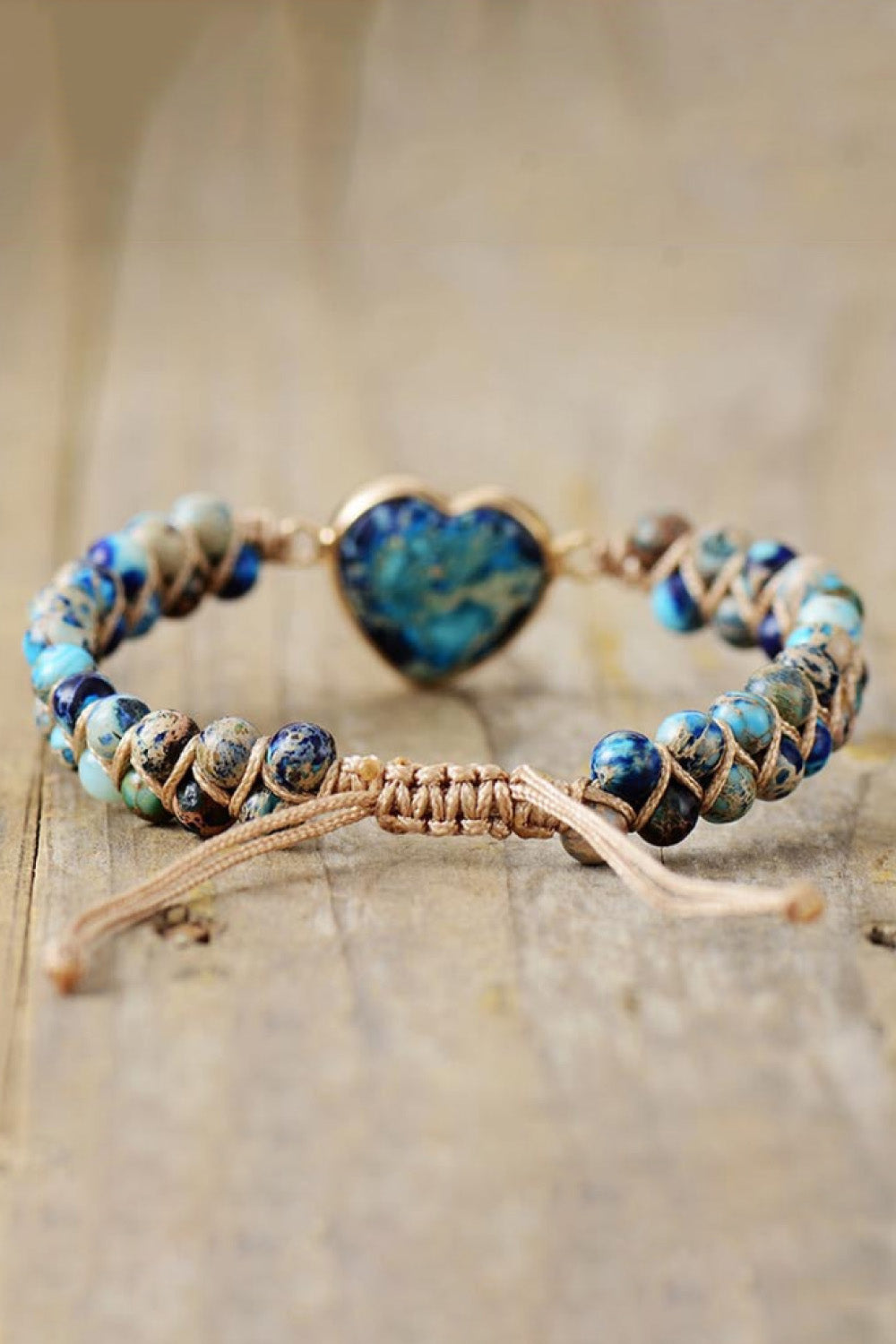 Braided bracelet with blue marbled heart stone and assorted blue and tan beads