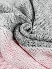 Colorblock knit sweater in pink and gray acrylic with crochet yoke detail.
