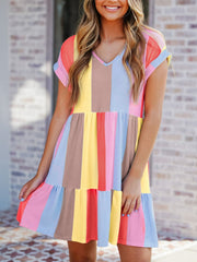 Babydoll dress with colorful vertical stripes, V-neck, short sleeves, and tiered hem.