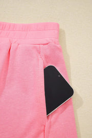 Dusty pink pocketed skort with elastic waistband and phone detail.