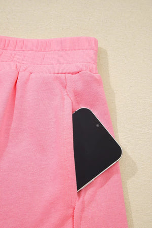 Dusty pink pocketed skort with elastic waistband and phone detail.