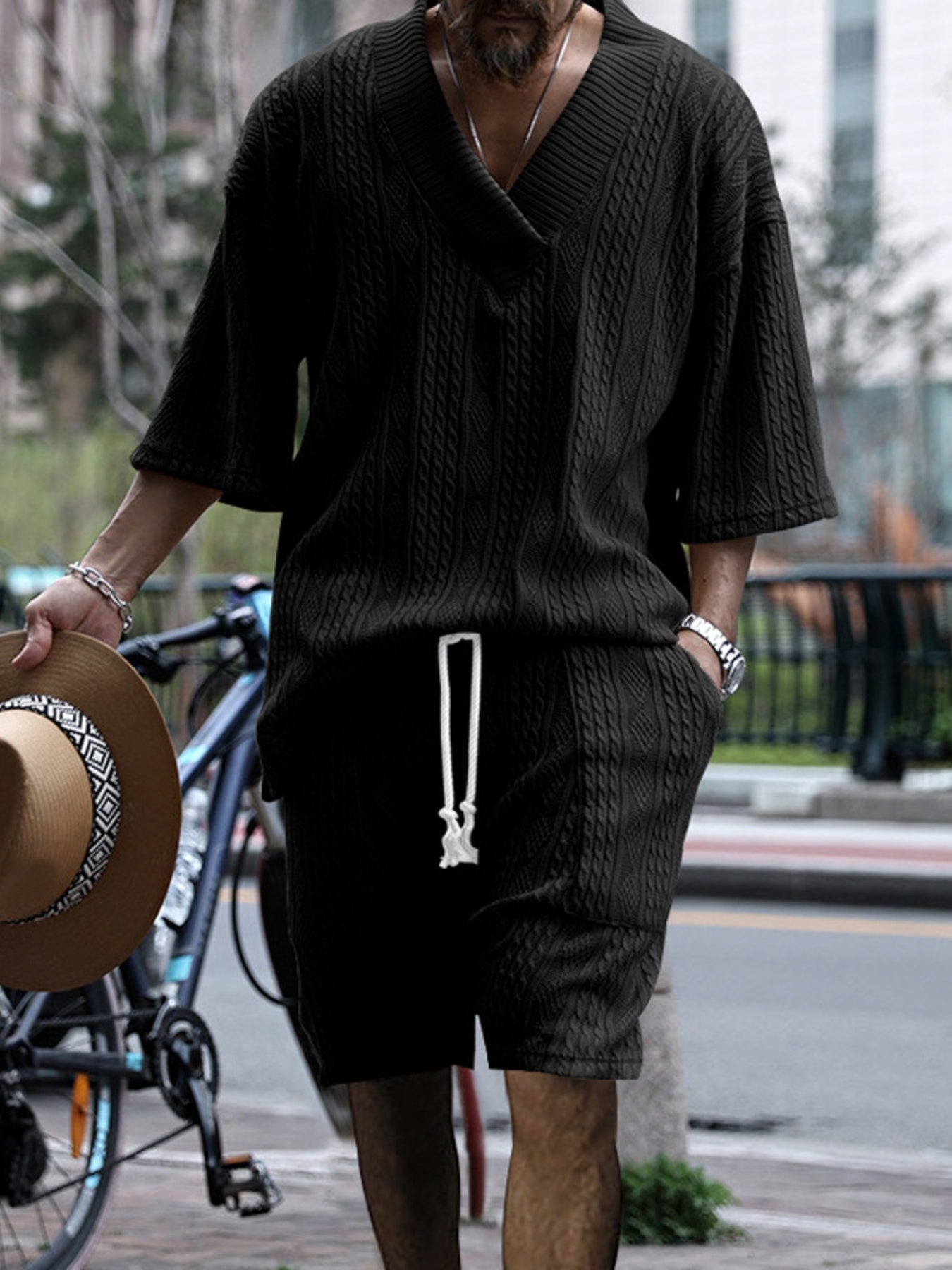 Black cable-knit v-neck two-piece set with drawstring shorts and short sleeves.