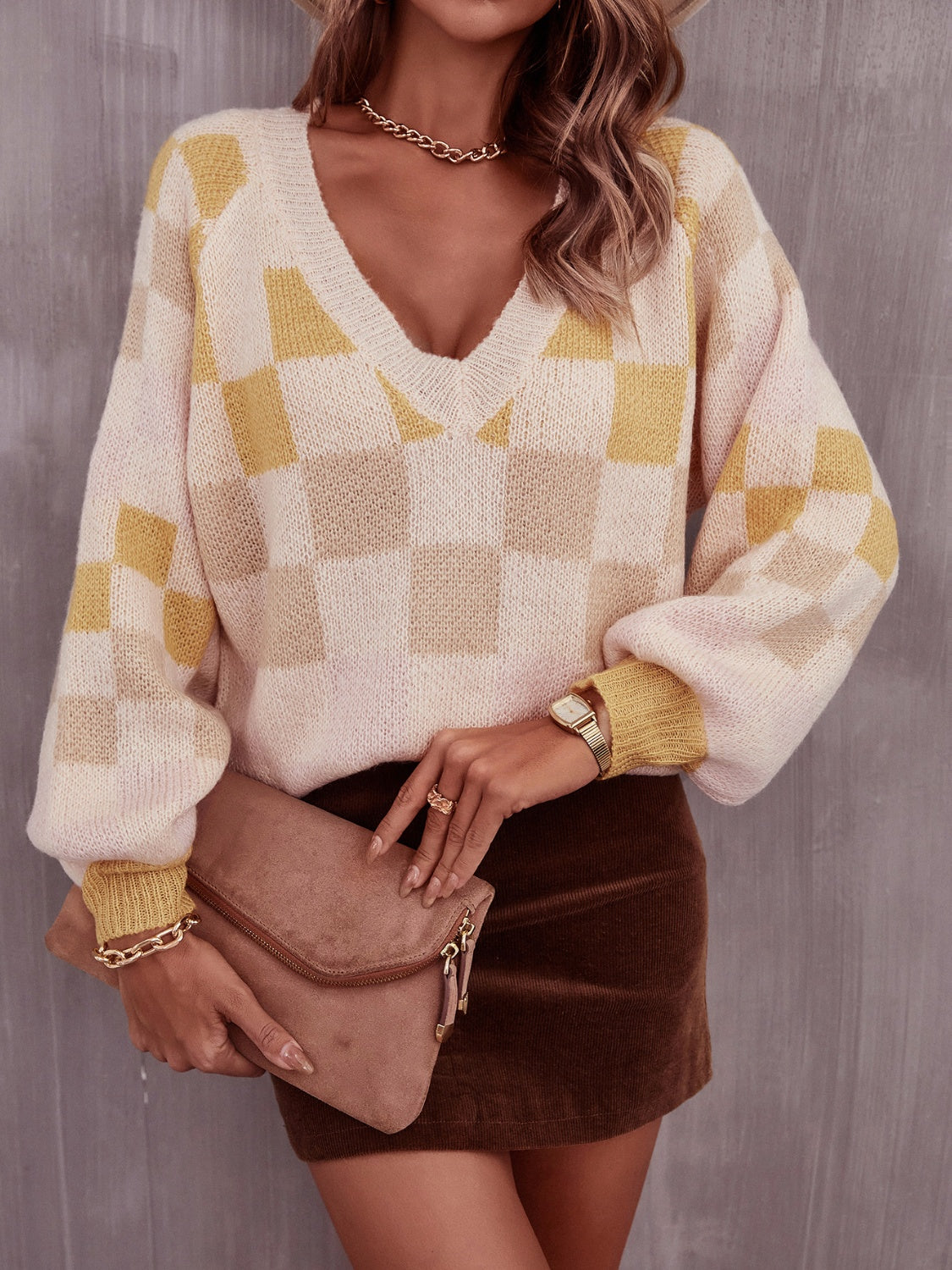Geometric checkerboard V-neck knit sweater with puff sleeves in cream and light yellow acrylic.