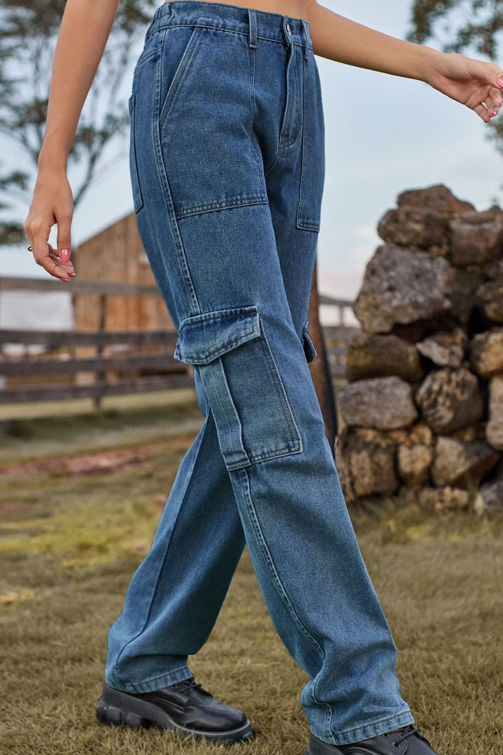 Medium wash denim cargo pants with multiple utility pockets and a straight leg cut.