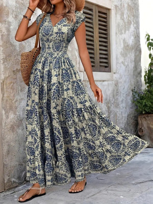 Blue damask print cap sleeve maxi dress with smocked waist and tiered skirt.