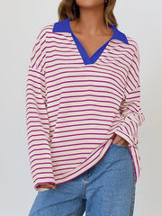Oversized striped long-sleeve sweatshirt with a blue collar and v-neck, in cream with magenta stripes.