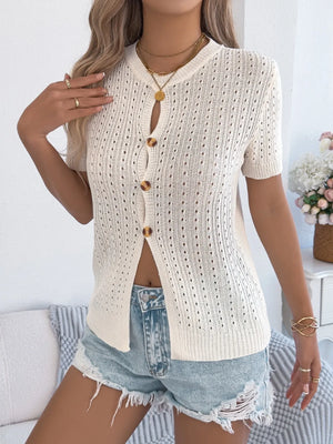 Cream knit short sleeve button-up cardigan with open knit detail and round neckline.
