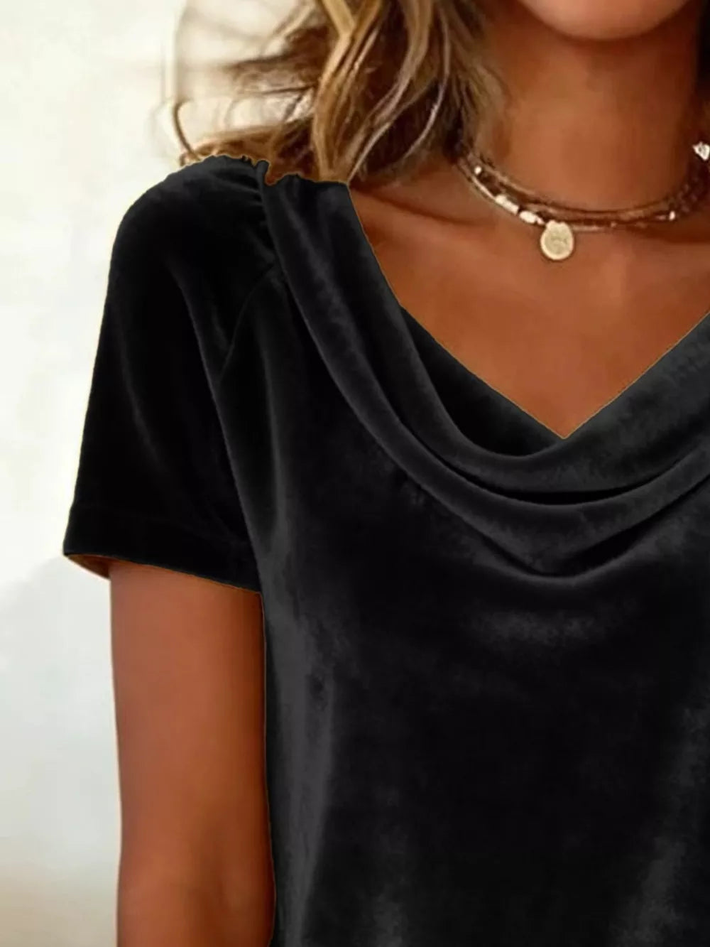 Black velvet t-shirt with cowl neck and short sleeves.