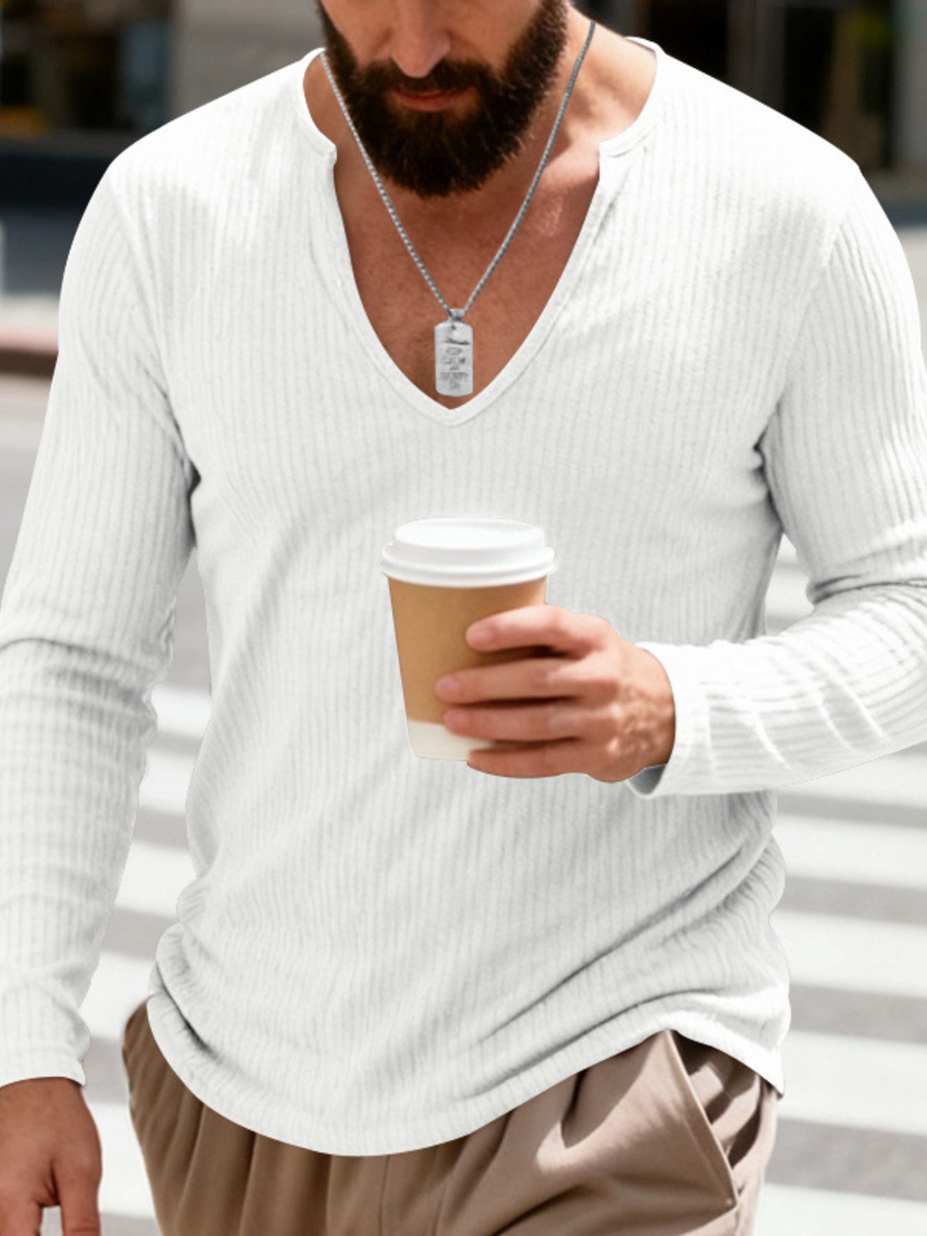 White ribbed long sleeve t-shirt with deep V-neck and a man holding a coffee cup.