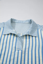 Classic blue and white striped collared cotton blouse with textured fabric detail.