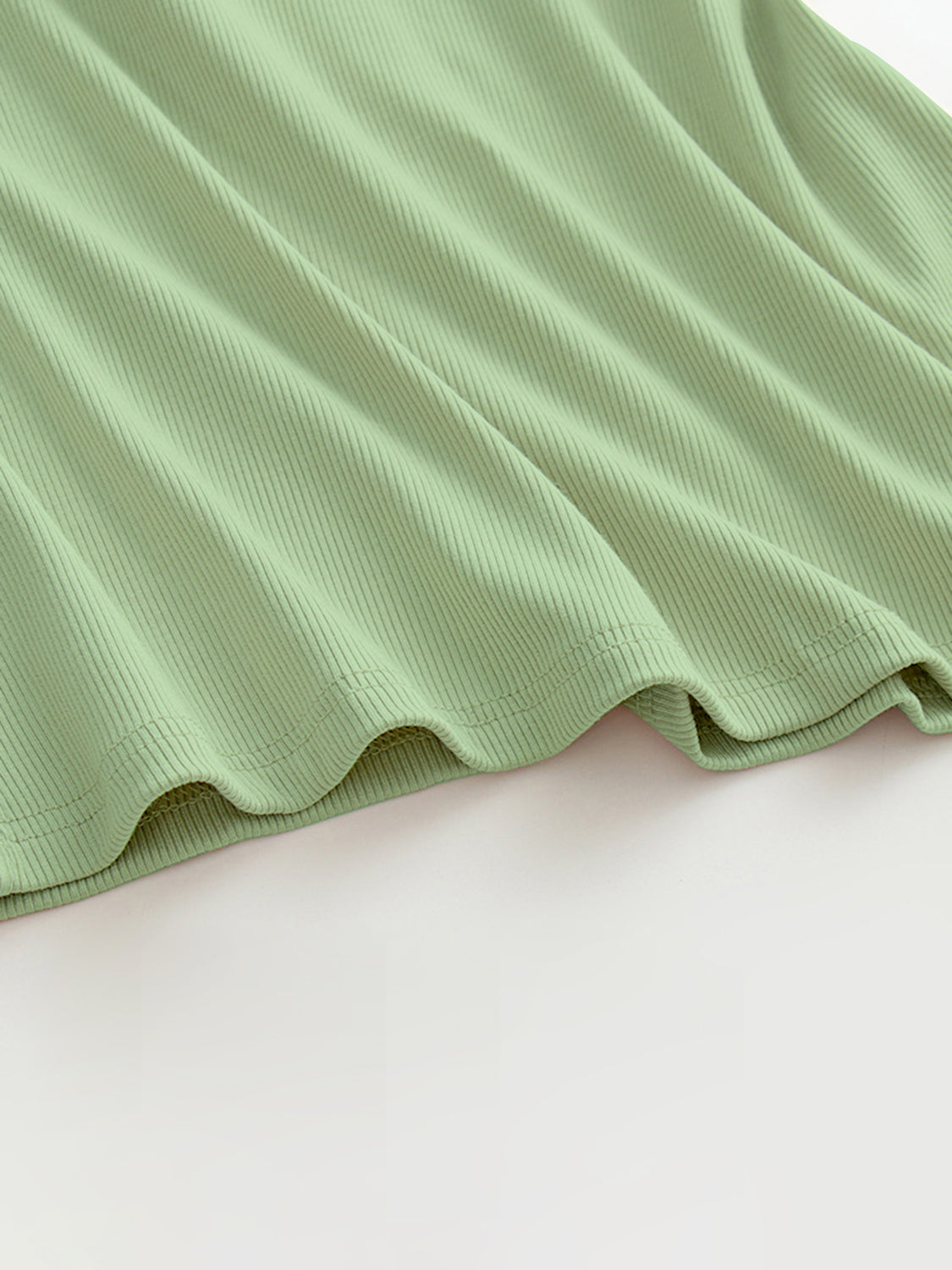 Ribbed halter tank top in Gum Leaf green with built-in bra detail.