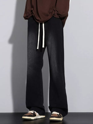 Men's black vintage wash jeans with drawstring and wide leg