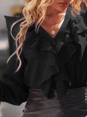 Black button front blouse with cascading ruffles and long sleeves.