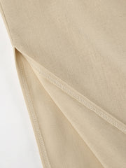 Tan cotton crop top and wide-leg pants set detail showing side slit and stitching.