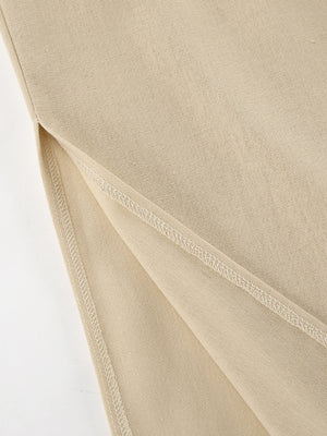Tan cotton crop top and wide-leg pants set detail showing side slit and stitching.