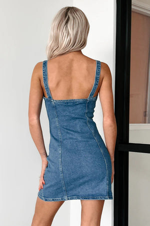 Button-down denim mini dress in medium blue with spaghetti straps and a fitted silhouette.