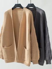 Chunky knit open-front cardigan in camel and dark gray with pockets and textured sleeves.