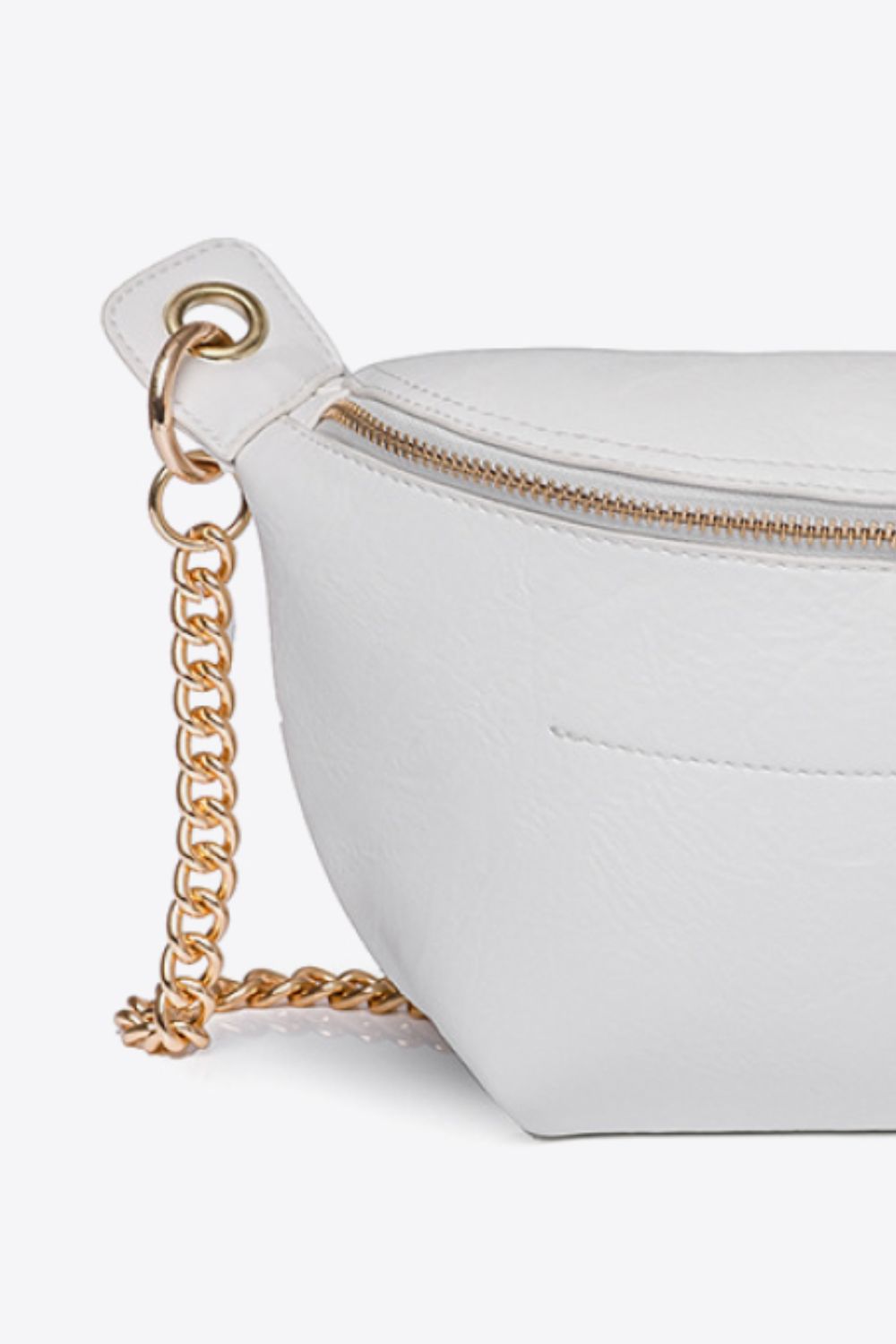 White crescent crossbody bag with gold chain detail and zipper closure
