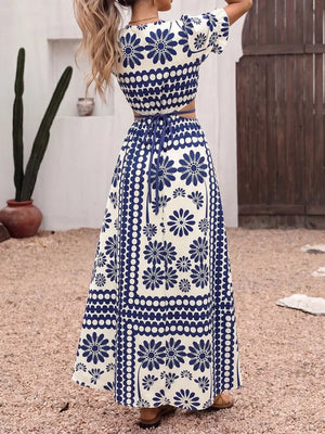 Maxi dress with blue floral print, cutout waist, tie detail, and short sleeves.
