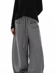 Gray wide-leg sweatpants with drawstring and pockets.