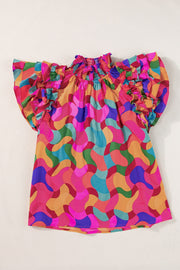 Kaleidoscope ruffle sleeve smocked blouse in hot pink with a colorful abstract wavy pattern.